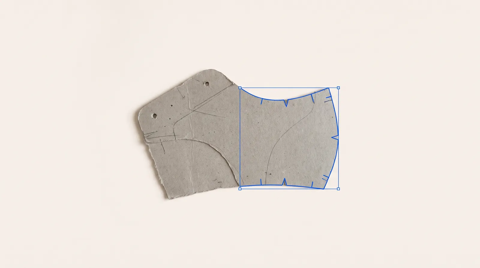 An old cardboard pattern, half retraced as a clean blue outline.